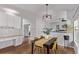 Cozy dining area with hardwood floors, modern light fixture, and stylish decor, creating an inviting space for meals at 10345 Lions Heart, Lone Tree, CO 80124
