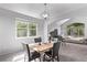 Elegant dining room offers ample natural light, modern lighting fixture and seating for four, with beautiful backyard views at 10345 Lions Heart, Lone Tree, CO 80124
