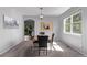 Bright dining room features modern decor, ample space, natural light, and is adjacent to the kitchen and backyard patio at 10345 Lions Heart, Lone Tree, CO 80124