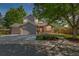 Charming two-story home featuring a brick and gray exterior, well-manicured lawn, and inviting front porch at 10345 Lions Heart, Lone Tree, CO 80124