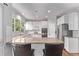 Bright kitchen features white cabinets, stainless appliances, granite countertops, and a breakfast bar with seating at 10345 Lions Heart, Lone Tree, CO 80124