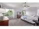 Main bedroom with a ceiling fan, two windows that provides natural light, and neutral carpeted floors at 10345 Lions Heart, Lone Tree, CO 80124