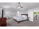 Spacious main bedroom with ensuite bathroom access, ceiling fan, natural light and neutral carpeting at 10345 Lions Heart, Lone Tree, CO 80124