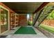 Covered patio with a brick wall, stairs leading to the deck, and an outdoor shelving unit at 10345 Lions Heart, Lone Tree, CO 80124