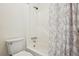Full bathroom featuring a toilet, a tub and shower combo, and a decorative shower curtain at 1529 S Sable Blvd # C, Aurora, CO 80012