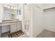 Bathroom with vanity, sink, storage and a walk-in closet with shelving at 1529 S Sable Blvd # C, Aurora, CO 80012