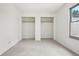 Bedroom features a neutral carpet, window and large closet with shelves at 1529 S Sable Blvd # C, Aurora, CO 80012