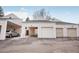 View of garages and carport with neutral siding and asphalt driveway at 1529 S Sable Blvd # C, Aurora, CO 80012