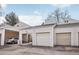 View of garages and carport with neutral siding and asphalt driveway at 1529 S Sable Blvd # C, Aurora, CO 80012