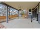 Spacious covered back patio featuring a ceiling fan, gray posts, and a concrete base at 16273 E Prentice Pl, Centennial, CO 80015