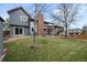 Home's backyard featuring a patio, shed, green grass, and mature trees at 16273 E Prentice Pl, Centennial, CO 80015