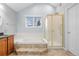 Full bathroom featuring a soaking tub, glass enclosed shower and tile floors at 16273 E Prentice Pl, Centennial, CO 80015