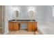 Large bathroom featuring double sinks, wooden cabinets, and a soaking tub at 16273 E Prentice Pl, Centennial, CO 80015