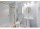Full bathroom with glass enclosed shower, pedestal sink, and decorative mirror and lighting at 16273 E Prentice Pl, Centennial, CO 80015