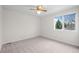 Bright bedroom featuring neutral carpet, a ceiling fan, and a window offering natural light at 16273 E Prentice Pl, Centennial, CO 80015