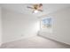 Bright bedroom featuring neutral carpet, a ceiling fan, and a window offering natural light at 16273 E Prentice Pl, Centennial, CO 80015