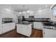Beautiful kitchen with island, stainless appliances, mosaic backsplash, and ample counter space at 16273 E Prentice Pl, Centennial, CO 80015