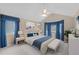 Main bedroom with vaulted ceiling, ceiling fan, and large windows with stylish curtains at 16273 E Prentice Pl, Centennial, CO 80015