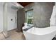 Well-lit bathroom features a modern soaking tub, shower, and stylish fixtures at 600 Garfield St, Denver, CO 80206