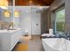 A luxurious bathroom with a freestanding tub, walk-in shower, and modern double vanity at 600 Garfield St, Denver, CO 80206