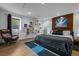Modern bedroom with wood floors, floating shelves, and comfortable furniture at 600 Garfield St, Denver, CO 80206