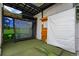 Indoor golf simulator room with high-tech equipment and putting green at 600 Garfield St, Denver, CO 80206