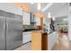 Spacious kitchen with stainless steel appliances, a large island, and modern lighting fixtures at 600 Garfield St, Denver, CO 80206