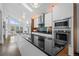 Modern kitchen featuring a large island, stainless steel appliances, and sleek white cabinetry at 600 Garfield St, Denver, CO 80206