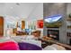 Open-concept living room with a fireplace, kitchen view, and modern furniture at 600 Garfield St, Denver, CO 80206