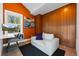 Cozy orange room featuring a work area, white loveseat and built in storage at 600 Garfield St, Denver, CO 80206