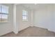 Neutral bedroom features neutral carpet, fresh white walls and two sunny windows overlooking the neighborhood at 2924 S Poppy St, Morrison, CO 80465