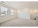 Bright bedroom features neutral carpet, two windows with neighborhood views, and fresh white walls at 2924 S Poppy St, Morrison, CO 80465