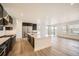 Modern kitchen featuring stainless steel appliances, a center island, and beautiful hardwood floors at 2924 S Poppy St, Morrison, CO 80465