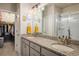 A stylish bathroom featuring double sinks, granite countertops, and a walk-in closet at 9305 S Gore St # C, Arvada, CO 80007