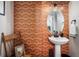 Stylish powder room featuring bold wallpaper, a pedestal sink, and decorative accents at 9305 S Gore St # C, Arvada, CO 80007