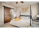 A primary bedroom featuring stylish sliding barn door to primary bath at 9305 S Gore St # C, Arvada, CO 80007