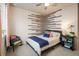 Cozy bedroom featuring a unique wood accent wall, soft textures, and elegant decor at 9305 S Gore St # C, Arvada, CO 80007
