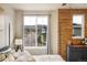A serene bedroom featuring a large window with neighborhood views and neutral decor at 9305 S Gore St # C, Arvada, CO 80007