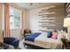 Bright bedroom with natural light, a decorative wood wall, and contemporary furnishings at 9305 S Gore St # C, Arvada, CO 80007