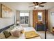 A calming bedroom showcasing a large window, stylish furnishings, and neutral tones at 9305 S Gore St # C, Arvada, CO 80007