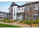 A modern townhome featuring a mix of textures, neat landscaping, and inviting front patio seating at 9305 S Gore St # C, Arvada, CO 80007