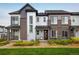 Modern townhome showcasing stylish architecture, a well-manicured lawn, and inviting front porch seating at 9305 S Gore St # C, Arvada, CO 80007