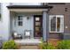 Inviting front porch features seating, modern accents, and brick and siding details at 9305 S Gore St # C, Arvada, CO 80007