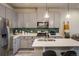 Modern kitchen with stainless steel appliances, a gray backsplash, and a quartz countertop at 9305 S Gore St # C, Arvada, CO 80007