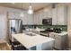 Bright kitchen with stainless steel appliances, green tile backsplash, and center island with bar seating at 9305 S Gore St # C, Arvada, CO 80007