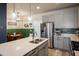 Open kitchen featuring stainless steel appliances, a center island, and adjacent dining area at 9305 S Gore St # C, Arvada, CO 80007