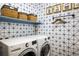 Modern laundry room showcasing a washer and dryer and stylish geometric patterned wall at 9305 S Gore St # C, Arvada, CO 80007