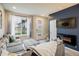 Cozy living room with a comfortable sectional, electric fireplace, and adjacent stairwell at 9305 S Gore St # C, Arvada, CO 80007