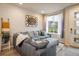 Inviting living room featuring a comfortable gray sectional sofa and modern decorative wall art at 9305 S Gore St # C, Arvada, CO 80007