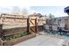 Backyard deck with dining area and privacy fence, complemented by a flower bed full of tulips at 3820 S Fraser St, Aurora, CO 80014